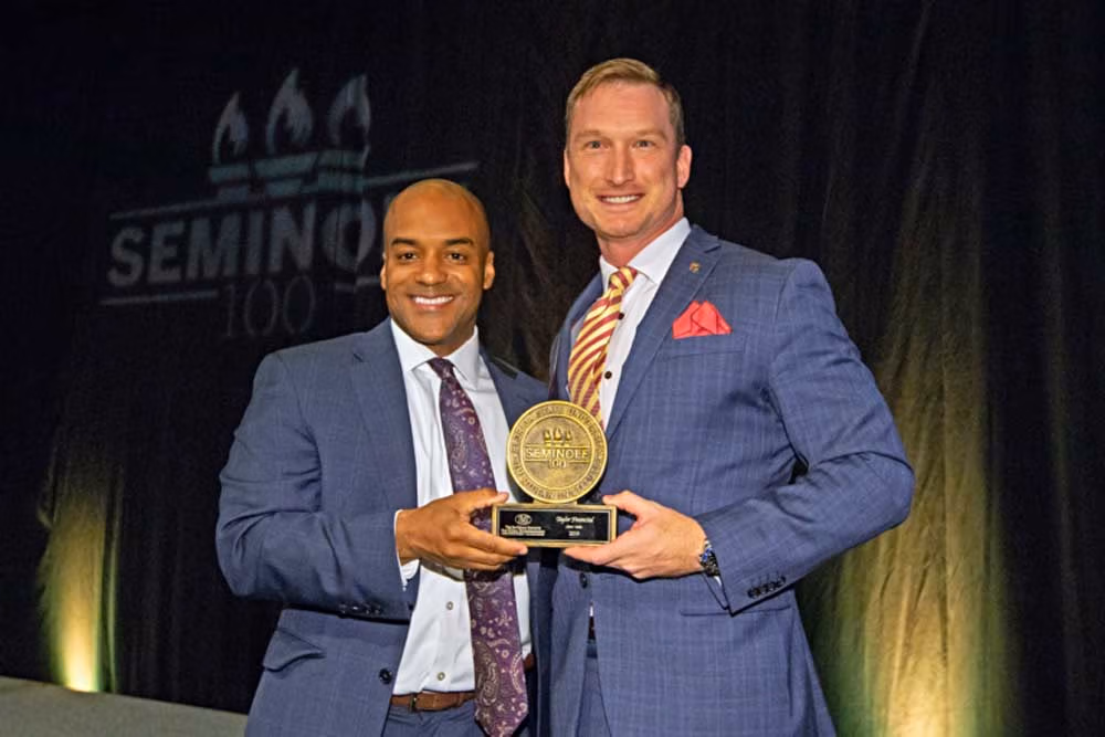 Taylor Financial accepting the Seminole 100 award on stage